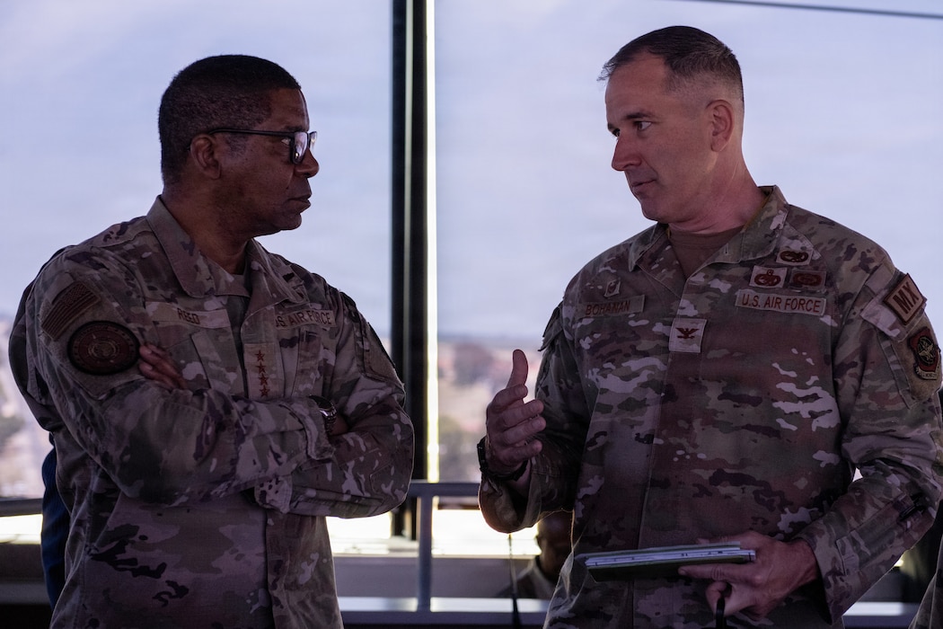 USTRANSCOM commnader talking with 60th Maintenance Group commander