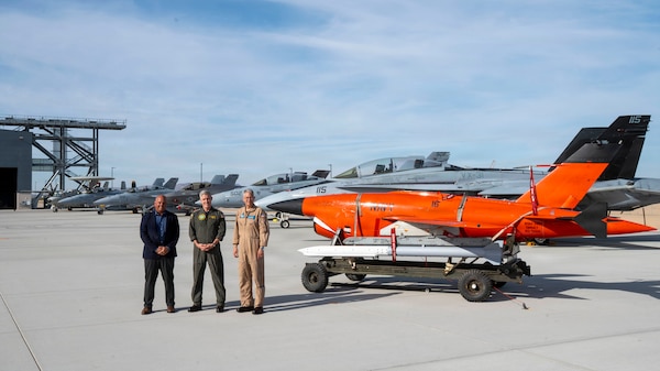 U.S. Navy Adm. Steve Koehler, commander, U.S. Pacific Fleet, center, U.S. Navy Rear Adm. Keith Hash, commander, Naval Air Warfare Center Weapons Division (NAWCWD), right, and Dan Carreño, executive director, NAWCWD, pose for a photo with aircraft and equipment used for weapons testing during a visit to Naval Air Weapons Station China Lake, California, June 2, 2026. U.S. Pacific Fleet delivers combat-ready naval forces to defend the homeland and U.S. interests throughout the region, provide credible deterrence, and strengthen U.S. alliances and partnerships to ensure a secure and prosperous Indo-Pacific. (U.S. Navy photo by Mass Communication Specialist 2nd Class Christopher Sypert)