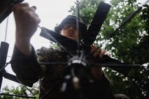 U.S. Marine Corps Lance Cpl. Caleb Appling, a native of Georgia and a transmissions systems operator with 7th Communication Battalion, III Marine Expeditionary Force Information Group, sets up a portable multi-band tactical antenna system during Kaiju Rain 26 at Camp Hansen, Okinawa, Japan, May 10, 2026.