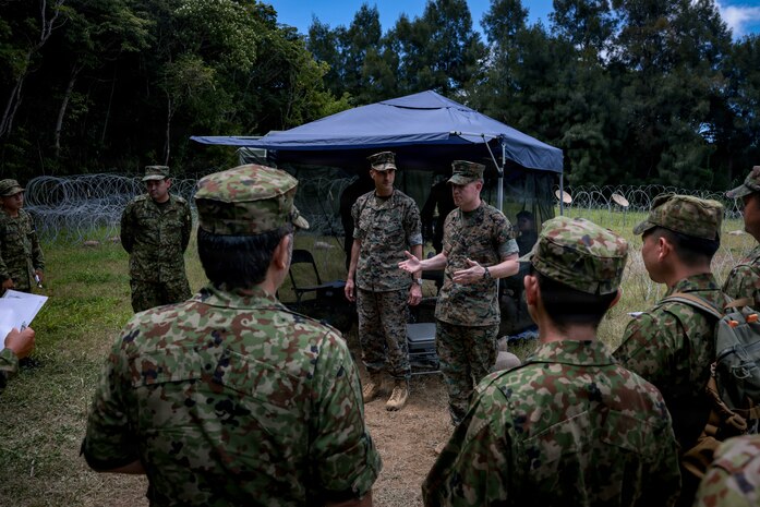 U.S. Marine Corps Sgt. Maj. Steven Toth, a native of Nevada and the sergeant major of 3d Intelligence Battalion, III Marine Expeditionary Force Information Group, briefs Japan Ground Self-Defense Force soldiers during Kaiju Rain 26 at Camp Hansen, Okinawa, Japan, May 20, 2026.