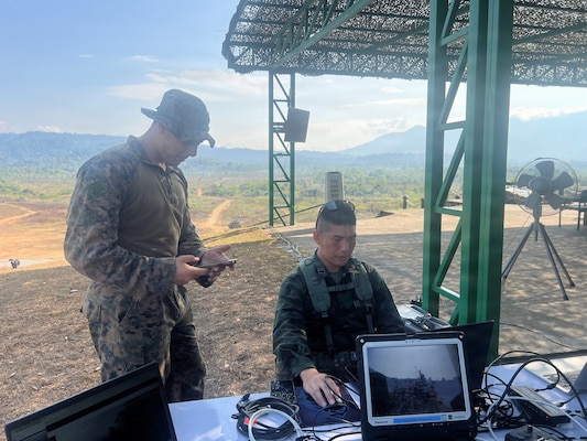 U.S. Marine Corps Sgt. Christian Hannah, assigned to15th Marine Expeditionary Unit, I Marine Expeditionary Force, and Royal Thai Marine Corps Division LT. j.g.Nuttachid Tuntha, read data provided by Tactical Assault/Team Awareness kits placed on the armored vehicles at the combined arms live-fire exercise during Exercise Cobra Gold 2026, in Ban Chan Khrem, Chanthaburi province, Thailand, March 6, 2026.