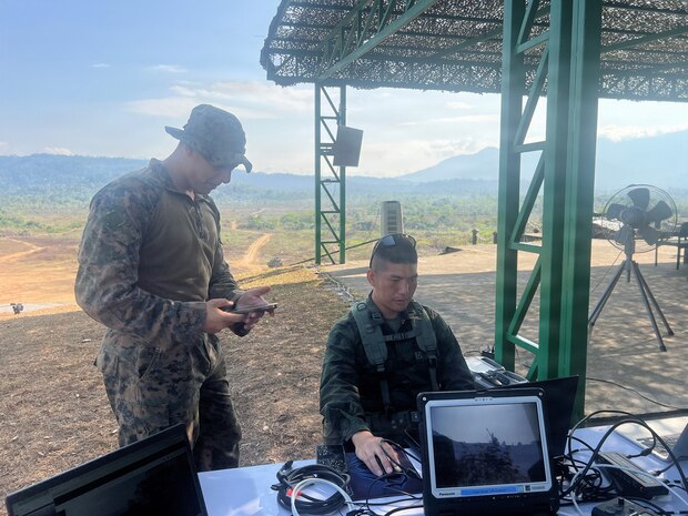 U.S. Marine Corps Sgt. Christian Hannah, assigned to15th Marine Expeditionary Unit, I Marine Expeditionary Force, and Royal Thai Marine Corps Division LT. j.g.Nuttachid Tuntha, read data provided by Tactical Assault/Team Awareness kits placed on the armored vehicles at the combined arms live-fire exercise during Exercise Cobra Gold 2026, in Ban Chan Khrem, Chanthaburi province, Thailand, March 6, 2026.