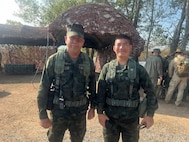 Cmdr. Suban Songsawas and LT. j.g.Nuttachid Tuntha, both with the Royal Thai Marine Corps Division, prepare to track force movements using Tactical Assault/Team Awareness kits placed on armored vehicles at the combined arms live-fire exercise during Exercise Cobra Gold 2026, in Ban Chan Khrem, Chanthaburi province, Thailand, March 6, 2026.