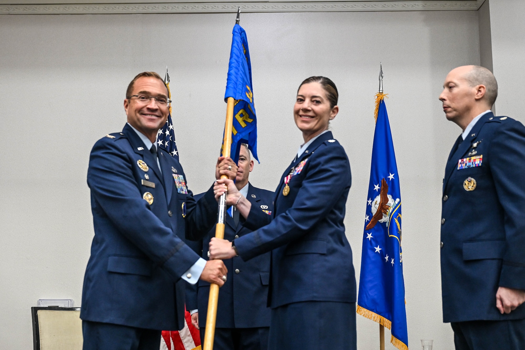 U.S. Air Force Lt. Col. Micah Bluto, 351st Recruiting Squadron, headquartered at Dobbins Air Reserve Base, Marietta, Georgia, passes guidon to U.S. Air Force Col. Sean “Metro” Fellows, 367th Recruiting Group commander, Robins Air Force Base, Georgia, during a Change of Command ceremony, June 4, 2026, Orlando, Florida. Bluto relieved command to U.S. Air Force Lt. Col. Jonathan L. Markley, 351 RCS incoming commander who now commands Air Force Reserve recruiters across 400,000 square miles, including 8 states, 1 territory, and 5 overseas units of 84 military and 9 civilian personnel, 59 recruiting offices, and 14 Military Entrance Processing Stations. (U.S. Air Force photo by Master Sgt. Della Creech)