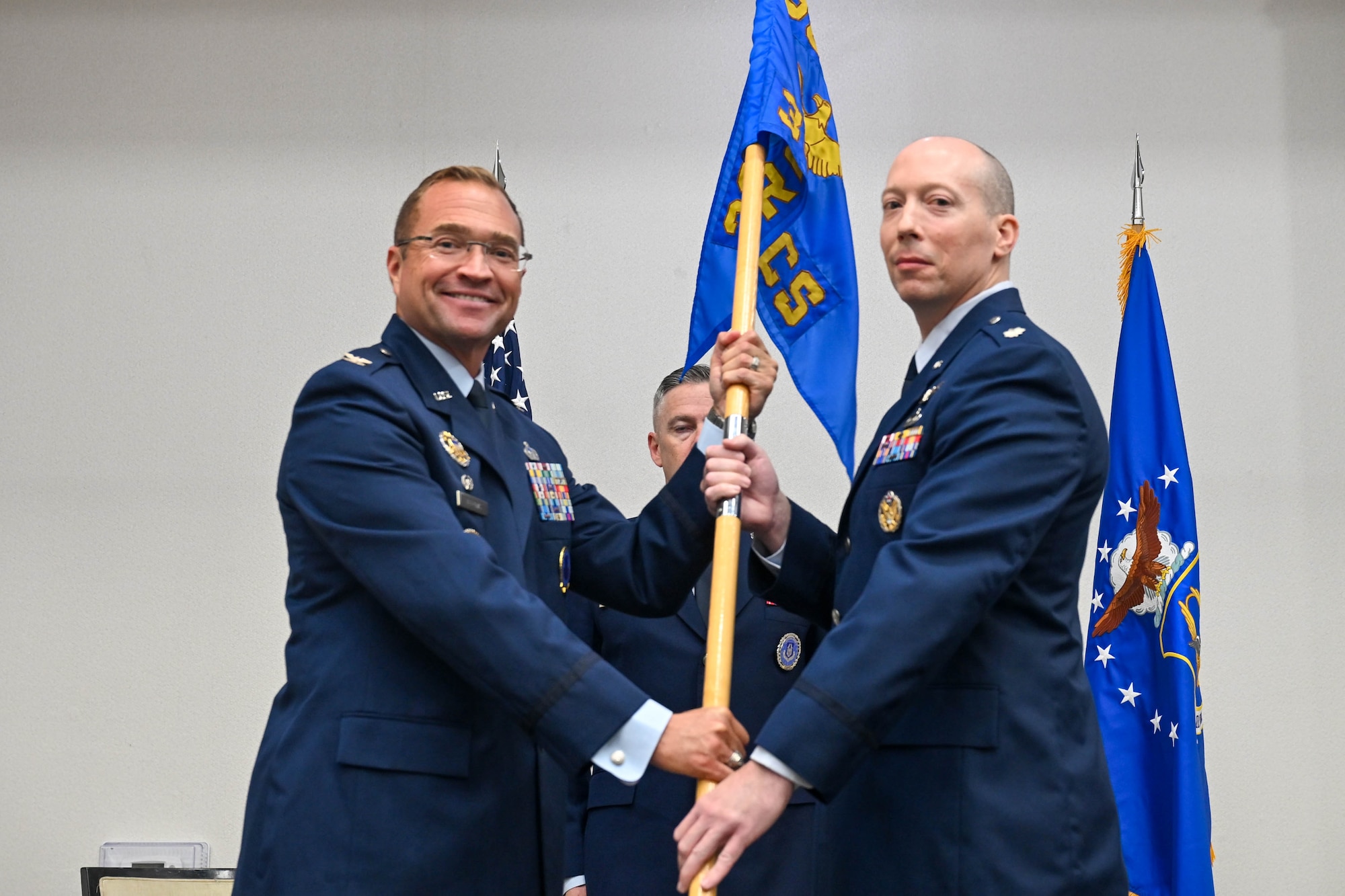 U.S. Air Force Col. Sean “Metro” Fellows, 367th Recruiting Group commander, Robins Air Force Base, Georgia, passes guidon to U.S. Air Force Lt. Col. Jonathan L. Markley, 351st Recruiting Squadron commander, headquartered at Dobbins Air Reserve Base, Marietta, Georgia, during the 351 RCS Change of Command ceremony, June 4, 2026, Orlando, Florida. Markley now commands Air Force Reserve recruiters across 400,000 square miles, including 8 states, 1 territory, and 5 overseas units of 84 military and 9 civilian personnel, 59 recruiting offices, and 14 Military Entrance Processing Stations. (U.S. Air Force photo by Master Sgt. Della Creech)