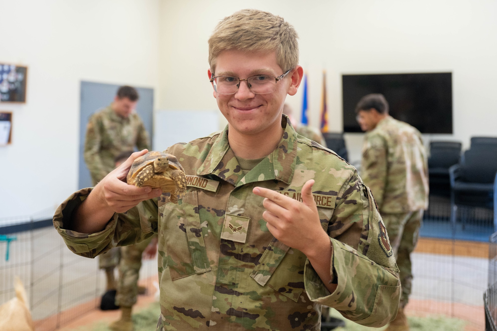 U.S. Air Force Airman 1st Class Hunter Hammond, 56th Component Maintenance Squadron aircrew egress apprentice, holds a tortoise at Luke Air Force Base, Arizona, June 3, 2026.