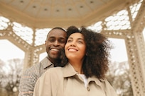 Picture of a man standing behind a woman as they smile