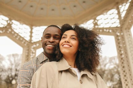 Picture of a man standing behind a woman as they smile