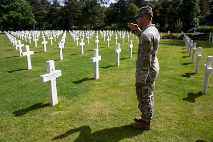U.S. Army Spc. David Kosciusko, assigned to 5th Squadron, 4th Cavalry Regiment, salutes the headstone of 2nd Lt. Jimmie Monteith Jr. at the Normandy American Cemetery in Normandy, France, June 2, 2026. Monteith, a 1st Infantry Division Soldier, was posthumously awarded the Medal of Honor for his actions during the D-Day invasion at Omaha Beach on June 6, 1944. (U.S. Army photo by Sgt. Joshua Fish)