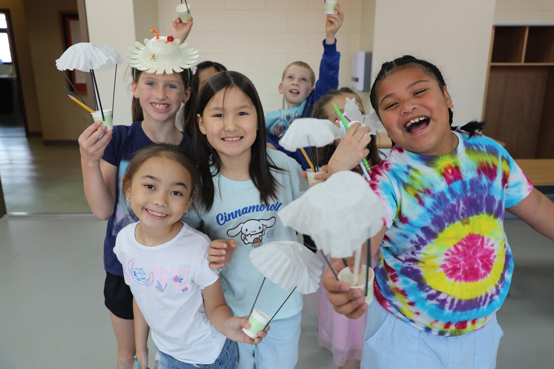 Students pose for a group photo with parachutes they created during a Science, Technology, Engineering, Arts and Mathematics (STEAM) event hosted by the U.S. Army Corps of Engineers – Far East District at Humphreys West Elementary School on Camp Humphreys, South Korea, May 18, 2026. Activities throughout the event encouraged students to think critically, solve problems and discover how engineering concepts apply to everyday life. (U.S. Army photo by Yohan An)