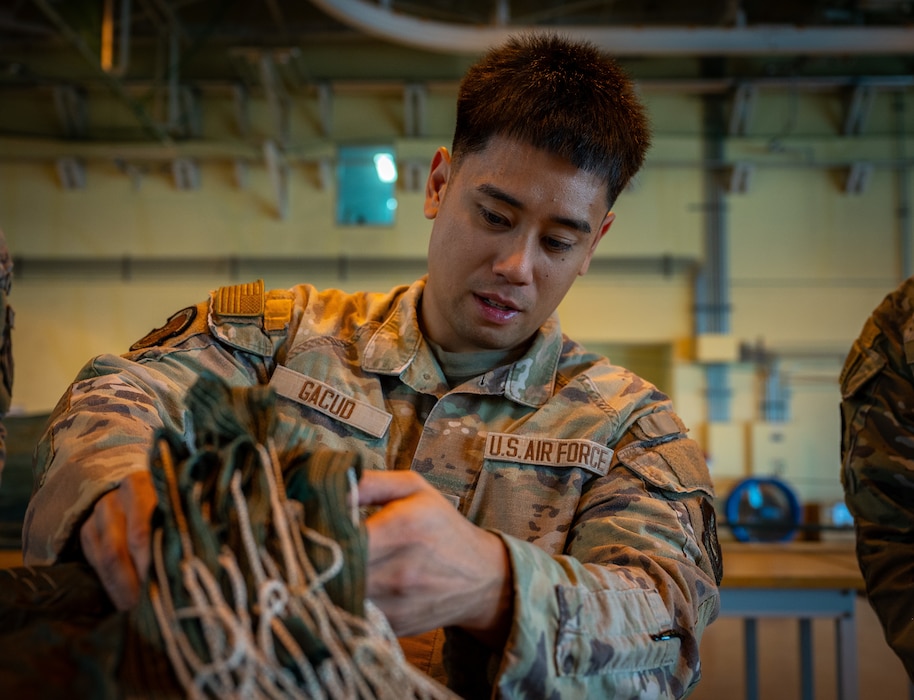 An Airman rigs a parachute.