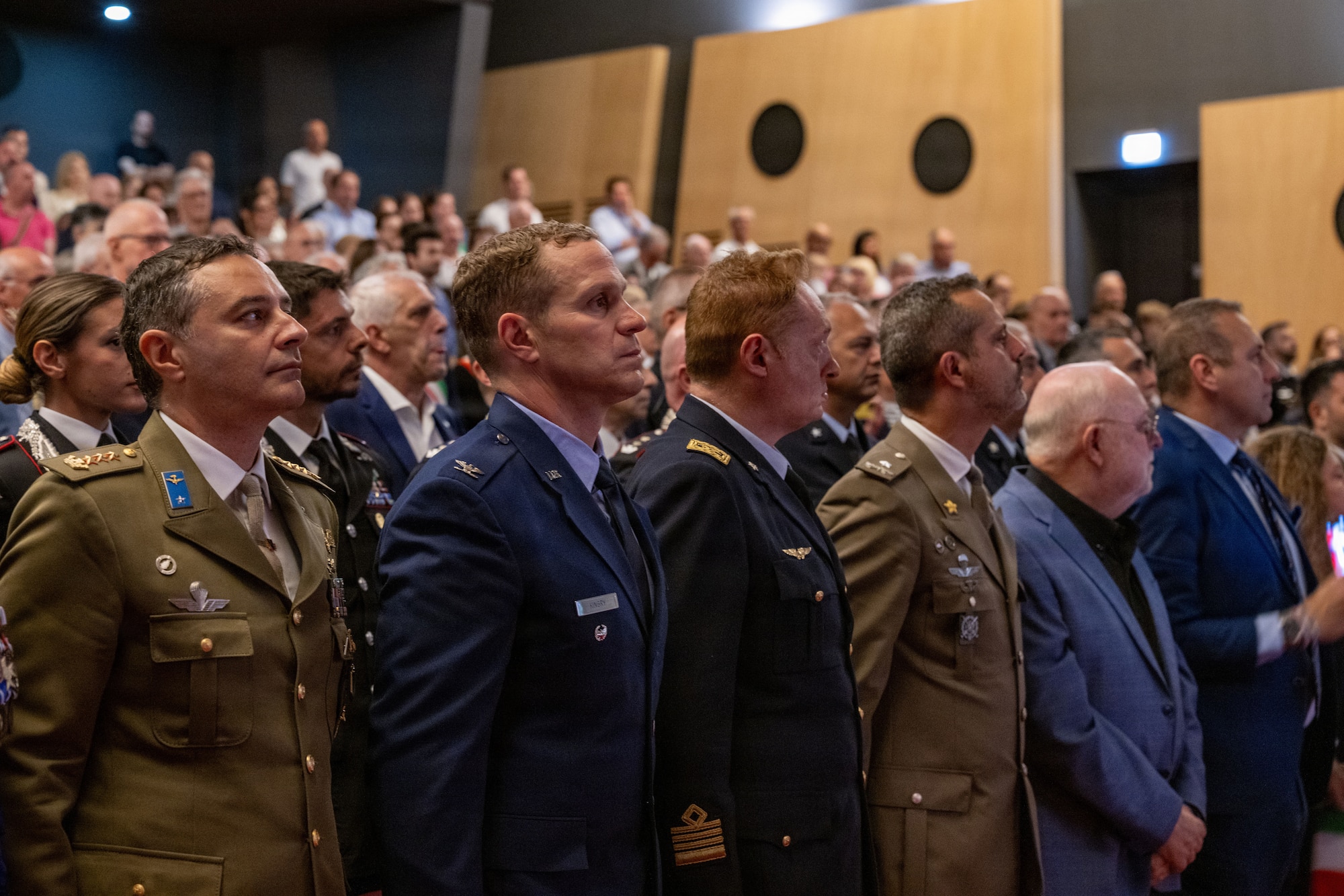 Men in military uniform stand together during a ceremony
