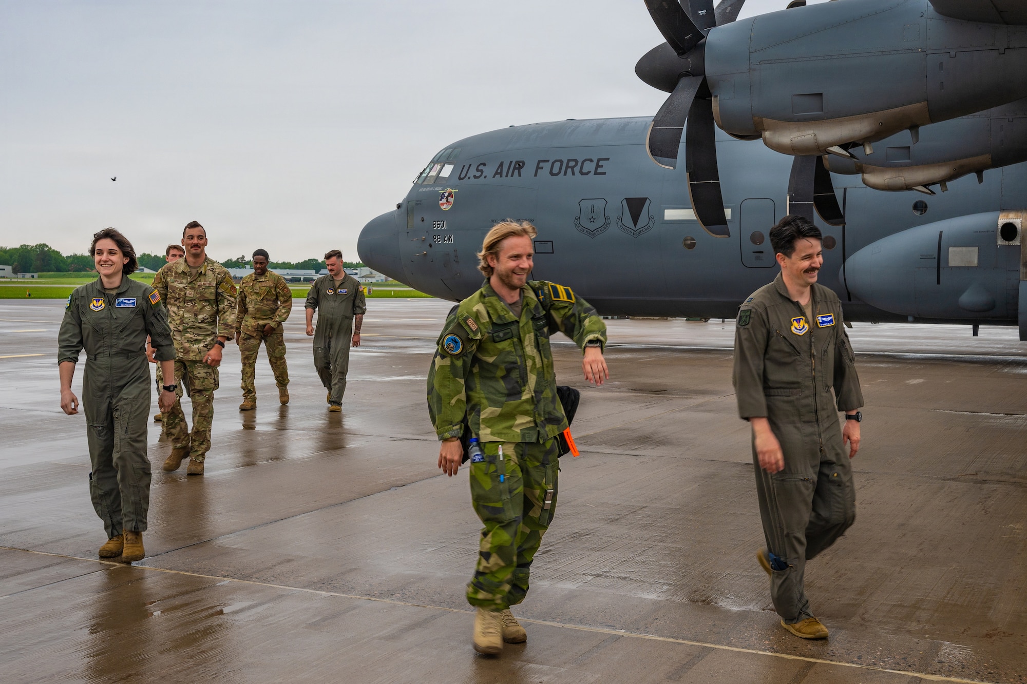A photo of Airmen walking next to an aircraft