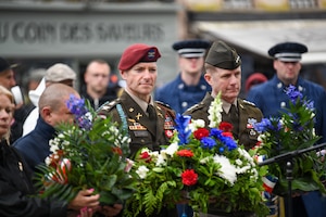 U.S. Army Lt. Gen. Curtis Buzzard, commanding general of Security Assistance Group–Ukraine (SAG-U) and NATO Security Assistance and Training for Ukraine (NSATU), and Army Col. Dan Leard, commander of the 3rd Brigade Combat Team, 82nd Airborne Division, prepare to lay a commerative wreath during the Airborne Ceremony in Sainte-Mère-Église, France, on June 3, 2026. The 82nd anniversary of D-Day is a reminder of the courage, sacrifice, and unity of the U.S. and Allied forces who fought to liberate the world from tyranny. U.S. service members assigned to units throughout Europe and the U.S. will participate in over 120 events and ceremonies between June 2-7, to commemorate the 82nd anniversary of D-Day in the Normandy region of France. (U.S. Army photo by Samantha Sergi)