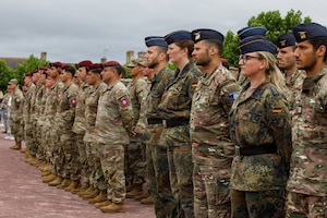 U.S. Soldiers assigned to the 82nd Airborne Division, 4th Infantry Division, First Army, and V Corps stand together with Soldiers of the French and German Armed Forces as part of a joint formation in a ceremony of remembrance of Gen. Dwight Eisenhower, 34th U.S. President, in Sainte-Mere-Eglise, France, June 3, 2026. U.S. service members assigned to units throughout Europe and the U.S. will participate in events and ceremonies June 2-7, to commemorate the 82nd anniversary of D-Day in the Normandy region of France. (U.S. Army photo by Sgt. 1st Class Brenden Delgado)