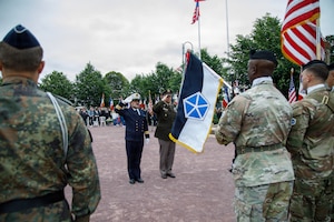 U.S. Army Lt. Gen. Mark Landes, commanding general for First Army, renders a salute with his French Naval Officer counterpart to the French, German, and U.S. Color Guard in a ceremony of remembrance of Gen. Dwight Eisenhower, 34th U.S. President, in Sainte-Mere-Eglise, France, June 3, 2026. U.S. service members assigned to units throughout Europe and the U.S. will participate in over 120 events and ceremonies June 2-7, to commemorate the 82nd anniversary of D-Day in the Normandy region of France. (U.S. Army photo by Sgt. 1st Class Brenden Delgado)
