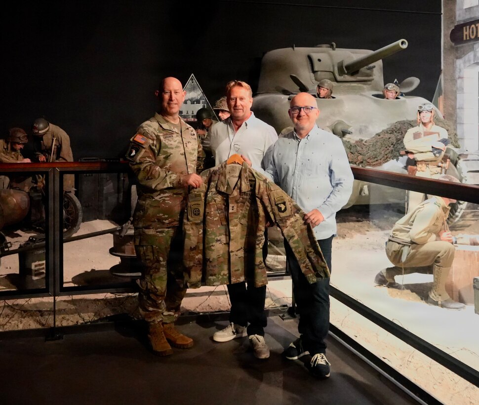 U.S. Army Maj. Gen. David Gardner, left, commanding general of the 101st Airborne Division (Air Assault), stands with Emmanuel Allain, center, and Michel De Trez, co-directors of the D-Day Experience Museum, following a uniform donation ceremony honoring the 82nd anniversary of D-Day in Normandy, France, June 2, 2026. The event serves to honor the past while educating future generations on the sacrifices made during WWII.