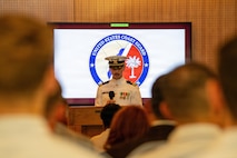 Emcee of the change of command speaks to attendees.