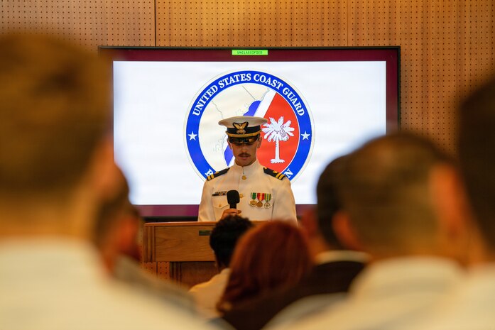 Emcee of the change of command speaks to attendees.