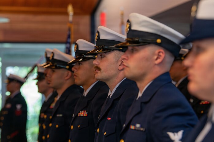 Coast Guard crewmembers standing at attention during the change of command.
