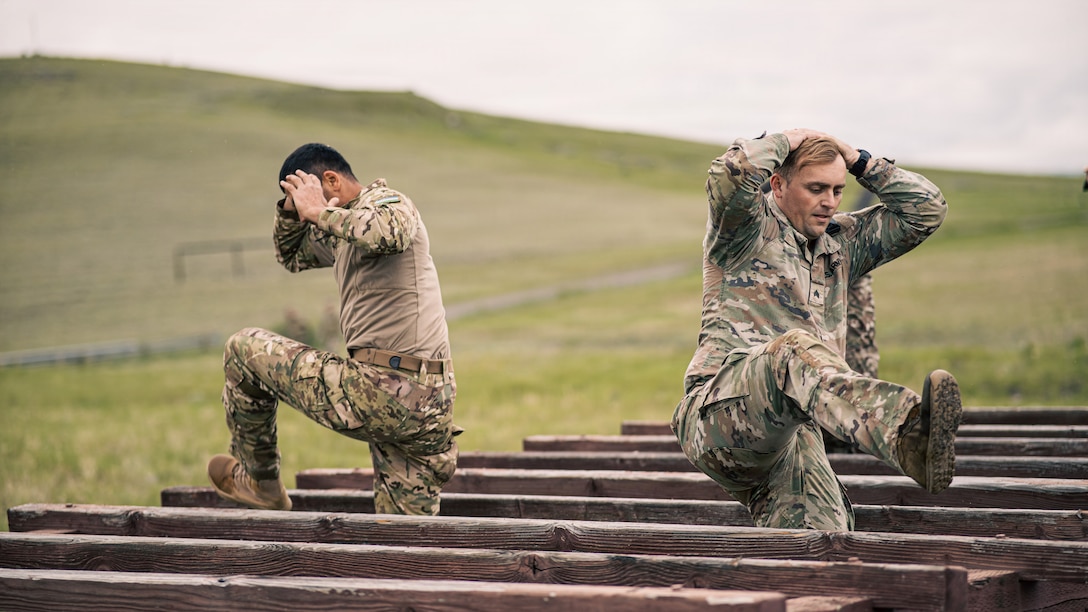 U.S. Army Sgt. Bryce Hill, assigned to the 179th Infantry Regiment, 45th Infantry Division, and an Uzbekistan partner navigate an obstacle during exercise Regional Cooperation 2026 at Fort Harrison, Montana, June 1, 2026. Regional Cooperation 2026 is an annual, multinational U.S. Central Command-sponsored command-post, field training and cyber defense exercise conducted by U.S. National Guard units in partnership with nations from Central and South Asia, and other participating nations. (Oklahoma National Guard photo by Sgt. Anthony Ackah-Mensah)