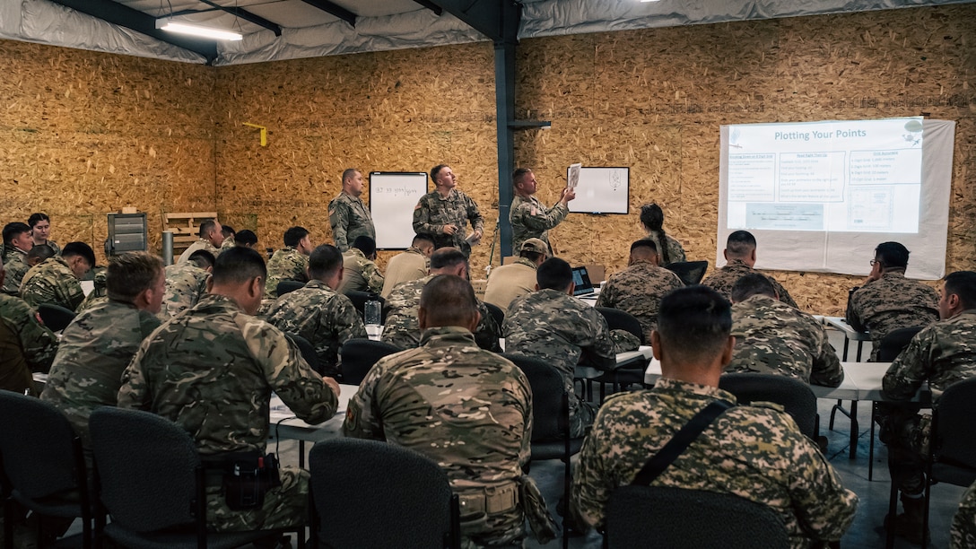 U.S. Army Maj. Christian Carter instructs a land navigation class for U.S. Army National Guardsmen and partners from Armenia, Georgia, Great Britain, Kazakhstan, the Kyrgyz Republic, Mongolia, Pakistan, Tajikistan and Uzbekistan during exercise Regional Cooperation 2026 at Fort Harrison, Montana, June 2, 2026. Regional Cooperation 2026 is an annual, multinational U.S. Central Command-sponsored command-post, field training and cyber defense exercise conducted by U.S. National Guard units in partnership with nations from Central and South Asia, and other participating nations. (Oklahoma National Guard photo by Sgt. Anthony Ackah-Mensah)