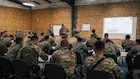 U.S. Army Maj. Christian Carter instructs a land navigation class for U.S. Army National Guardsmen and partners from Armenia, Georgia, Great Britain, Kazakhstan, the Kyrgyz Republic, Mongolia, Pakistan, Tajikistan and Uzbekistan during exercise Regional Cooperation 2026 at Fort Harrison, Montana, June 2, 2026. Regional Cooperation 2026 is an annual, multinational U.S. Central Command-sponsored command-post, field training and cyber defense exercise conducted by U.S. National Guard units in partnership with nations from Central and South Asia, and other participating nations. (Oklahoma National Guard photo by Sgt. Anthony Ackah-Mensah)