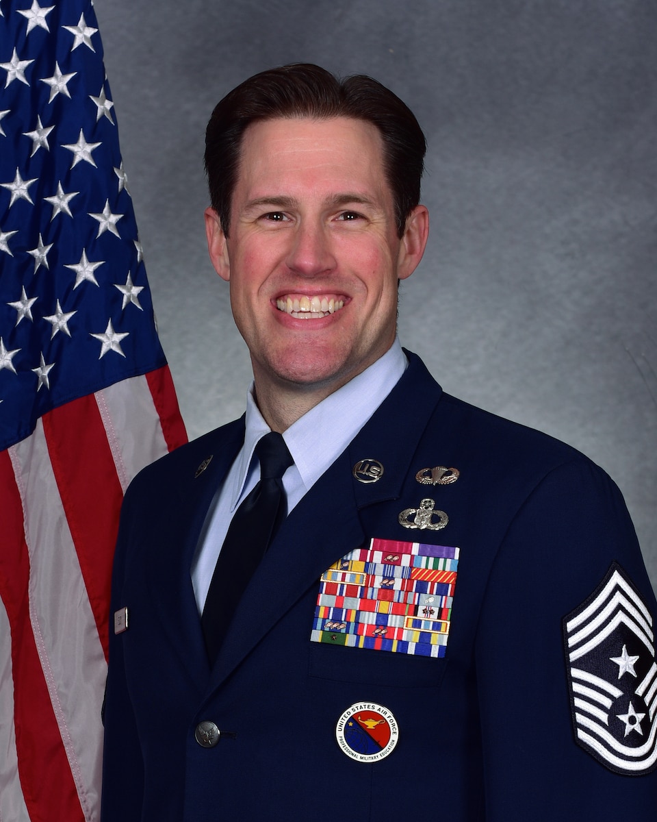 Man poses for official photo in uniform