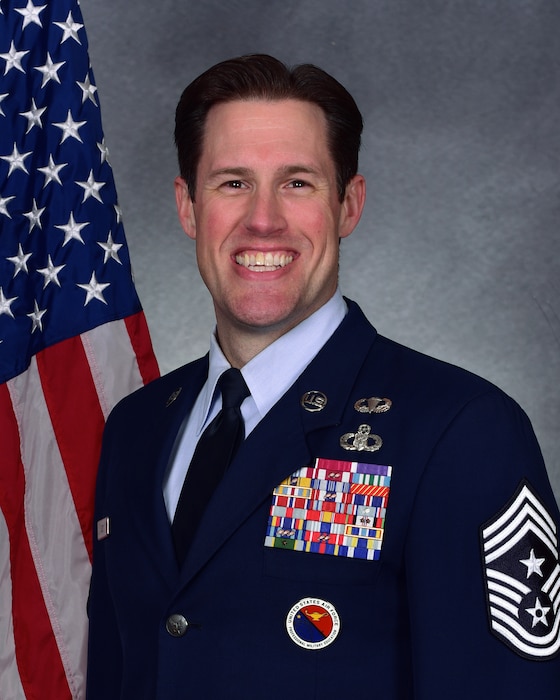 Man poses for official photo in uniform