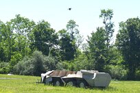 A Neros Archer first-person-view drone hovers above a simulated military vehicle during new equipment training at the Fort Indiantown Gap Unmanned Aircraft System Training and Innovation Facility June 3, 2026, at Fort Indiantown Gap, Pennsylvania. The Archer is the first of eight drones the Soldiers at the TIF will receive training on so that they can train other Soldiers as part of the Department of War’s Drone Dominance Program. (Pennsylvania National Guard photo by Brad Rhen)