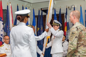 (260603-Z-DH100-1108)

GUANTANAMO BAY, Cuba (June 3, 2026) - Master Chief Hospital Corpsman Rashanta Pippins, senior enlisted leader, Joint Medical Group, Joint Task Force Guantanamo, passes the guidon to Capt. Tammy E. Servies during a change of command ceremony at the Bayview aboard Naval Station Guantanamo Bay, June 3, 2026. The passing of the guidon symbolizes the transfer of authority and responsibility from an outgoing commander to an incoming commander. Servies fulfilled three mission-critical roles as commanding officer of U.S. Navy Medicine Readiness and Training Command Guantanamo Bay, commander of Joint Medical Group, Joint Task Force Guantanamo, and hospital director of U.S. Naval Hospital Guantanamo Bay. (U.S. Army National Guard photo by Sgt. Ryan Lamb)