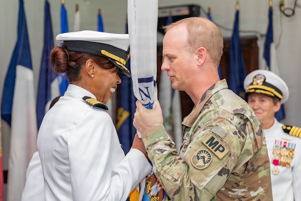 (260603-Z-DH100-1112)

GUANTANAMO BAY, Cuba (June 3, 2026) - Navy Capt. Toni A. Bowden, incoming commander, Joint Medical Group, Joint Task Force Guantanamo, receives the Joint Medical Group guidon from Army Col. Robert Eyman, commander, Joint Task Force Guantanamo, during a change of command ceremony at the Bayview aboard Naval Station Guantanamo Bay, June 3, 2026. Bowden assumed the roles of commander, Joint Medical Group, Joint Task Force Guantanamo, commanding officer of U.S. Navy Medicine Readiness and Training Command Guantanamo Bay, and director of U.S. Naval Hospital Guantanamo Bay during the ceremony. (U.S. Army National Guard photo by Sgt. Ryan Lamb)