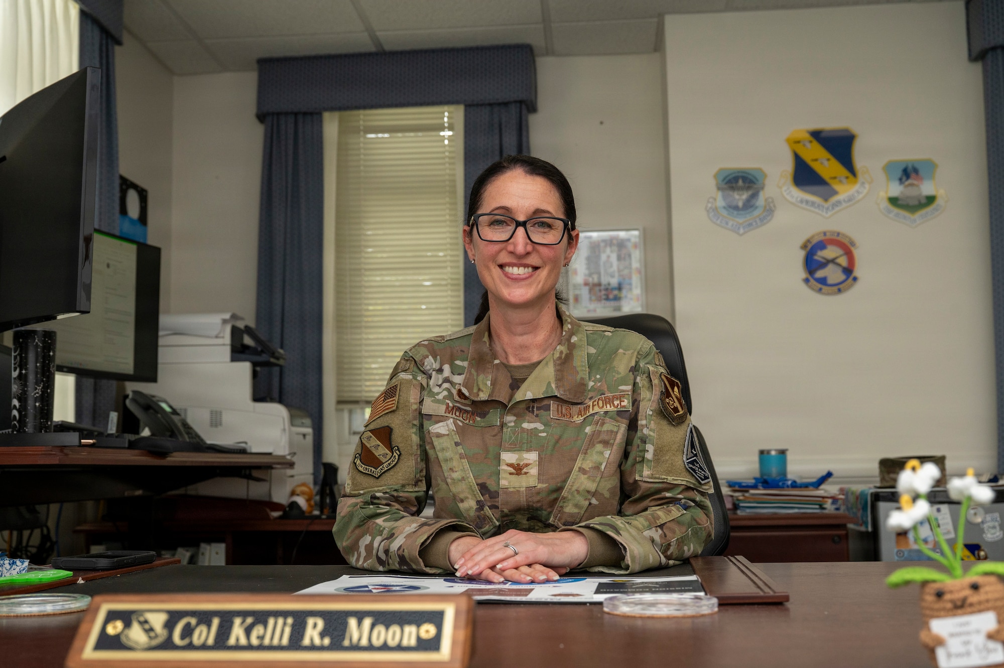 U.S. Air Force Col. Kelli R. Moon, commander of the 11th Operations Group at Joint Base Anacostia-Bolling, sits at her desk at JBAB, Washington, D.C. May 27, 2026. Moon has commanded the 11th Operations Group at JBAB since 2024, which oversees the U.S. Air Force Honor Guard, U.S. Air Force Band, Air Force Chaplaincy at Arlington National Cemetery, and the Air Force Memorial.  (U.S. Air Force photo by Senior Airman Shanel Toussaint)