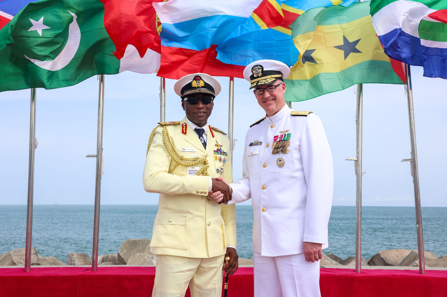 U.S. Navy Rear Adm. Scott W. Ruston, right, Vice Commander of U.S. Naval Forces Africa, shakes hands with Nigerian Navy Rear Adm. Abubakar Abdullahi Mustapha, Flag Officer Commanding of the Western Naval Command, at the International Fleet Review during the Nigerian Navy’s 70th Anniversary Celebration at the Eko Atlantic City Waterfront in Lagos, Nigeria, June 1, 2026.