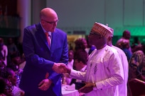 U.S. Navy Rear Adm. Scott W. Ruston, left, Vice Commander of U.S. Naval Forces Africa, shakes hands with Nigerian Navy Rear Adm. Chindo Usman Yahaya, Maritime Security Officer, during a Gala dinner during the Nigerian Navy’s 70th Anniversary Celebration inLagos, Nigeria, June 1, 2026.