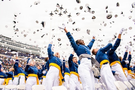 Graduating cadets from the U.S. Air Force Academy Class of 2026 toss their hats in the air as the U.S. Air Force Thunderbirds fly over Falcon Stadium in Colorado Springs, Colo., May 28, 2026. A total of 931 cadets received commissions as second lieutenants in the U.S. Air Force and U.S. Space Force. (U.S. Air Force photo by Adalyn Greene)