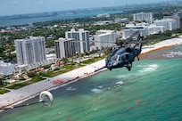 An HH-60G Pave Hawk assigned to the 920th Rescue Wing trails an HC-130J Combat King II during the Hyundai Air and Sea Show in Miami, Fla., May 24, 2026. The aircraft demonstrated the Air Force's combat search and rescue capabilities while showcasing the coordination required to recover and support isolated personnel in contested environments. (U.S. Air Force photo by Master Sgt. Darius Sostre-Miroir)