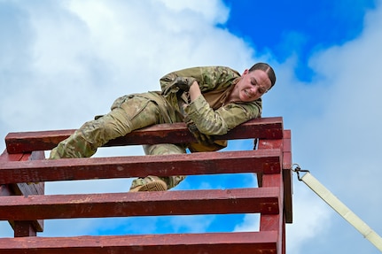 Staff Sgt. Cambrea Thompson, assigned to the 36th Security Forces Squadron, climbs an obstacle during the Pacific Air Forces' 9th Annual Advanced Combat Skills Assessment Competition at Northwest Field, Andersen Air Force Base, Guam, May 21, 2026. The combat agility portion of the competition tested participants through a series of physically demanding events, including a 35-pound ruck march, weapons familiarization and an obstacle course designed to evaluate readiness, endurance and warfighting skills. (U.S. Air Force photo by Airman 1st Class Xavier Romero)