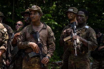 U.S. Air Force Staff Sgt. Duchaine Paul, right, assigned to the 824th Base Defense Squadron, stands with U.S. service members and Panamanian partners before the Green Mile event during the Jungle Operations Training Course-Panama, May 14, 2026. Paul became the first Airman to graduate from the course, strengthening interoperability between U.S. forces and Panamanian security institutions through combined jungle operations training. (U.S. Army photo by Sgt. Nirak Garcia Navarro)