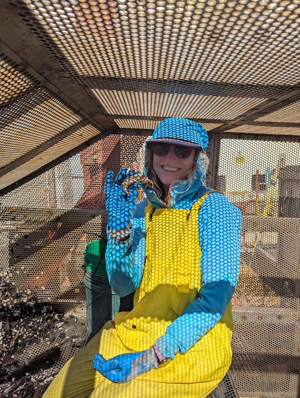 Biologist poses with crab.