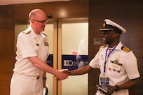 U.S. Navy Rear Adm. Scott W. Ruston, left, Vice Commander of U.S. Naval Forces Africa, shakes hands with Nigerian Navy Cmdr. Lamutal Orlando Bahaushe, assigned to the Deputy Defense Attaché, at the Sea Power for Africa Symposium, during the Nigerian Navy’s 70th Anniversary Celebration in Victoria Island, Lagos, Nigeria June 2, 2026.