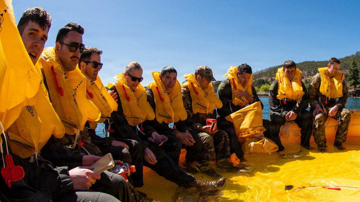 Airmen gathered on life raft during survival training