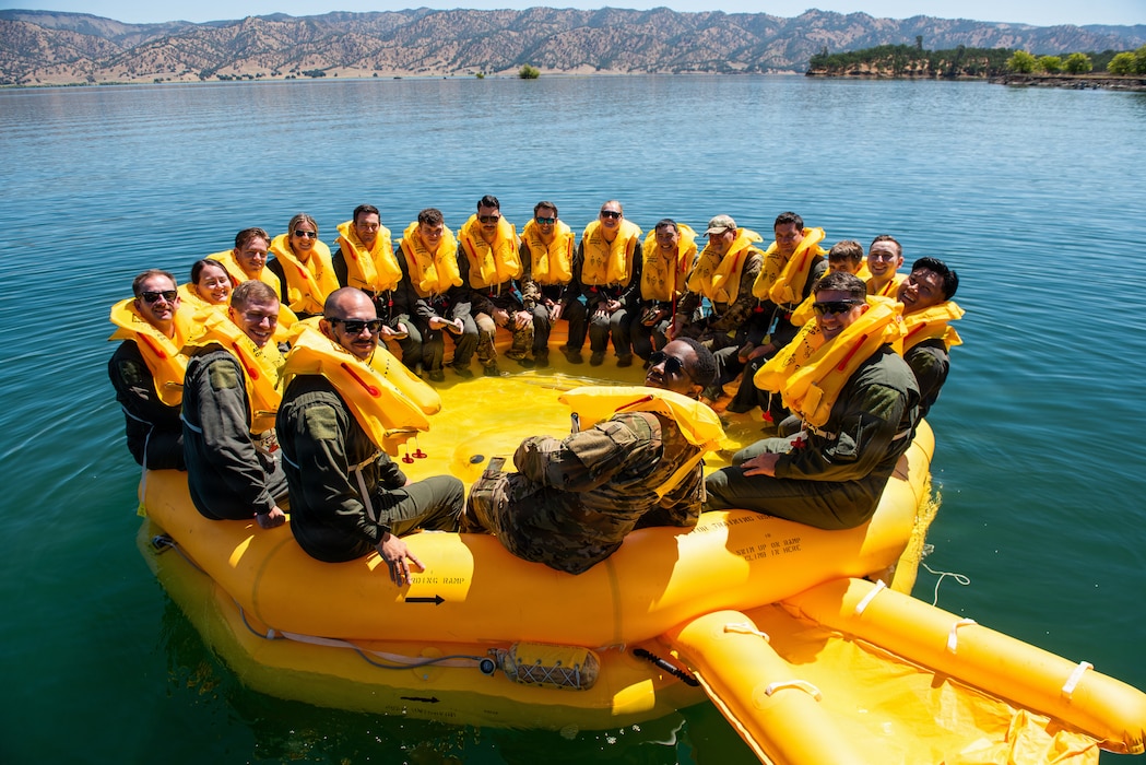 Airmen pose for group photo in life raft