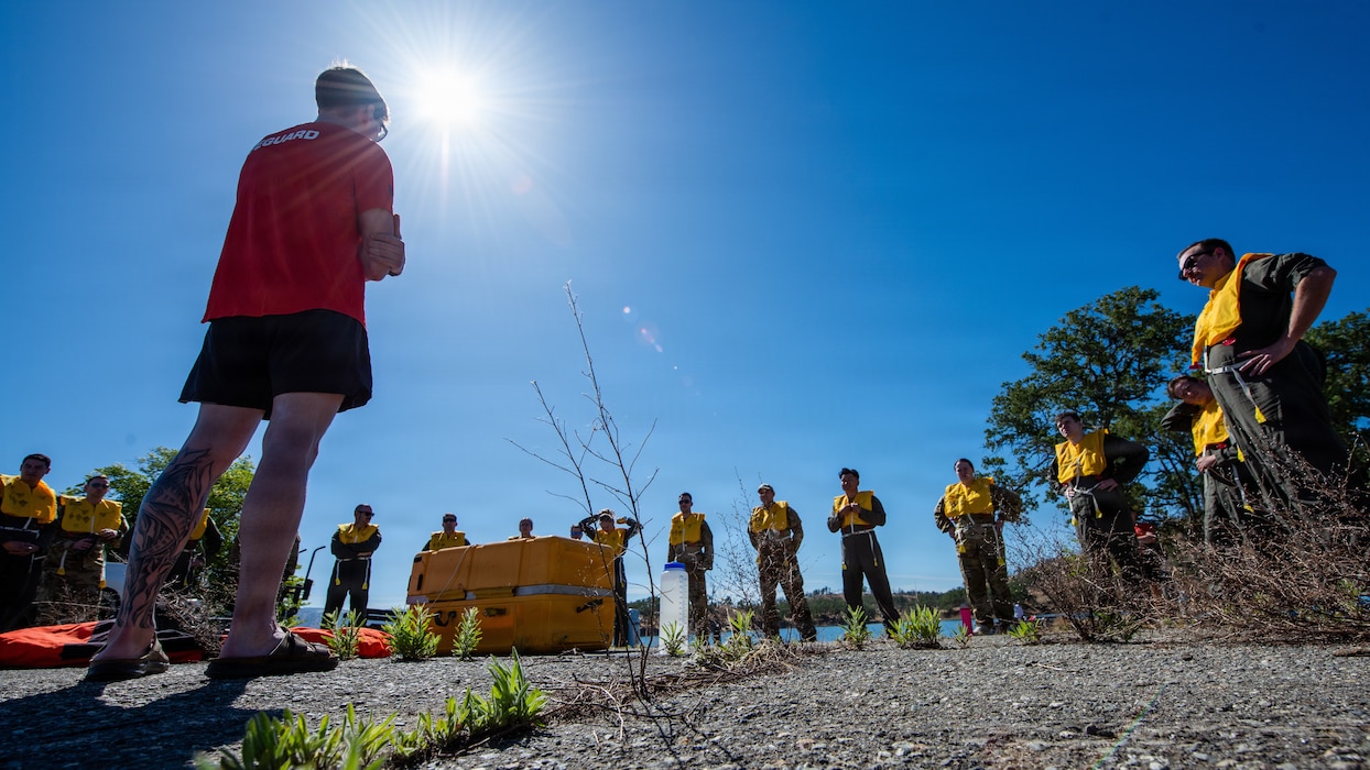 SERE specialist explains water survival skills on pier