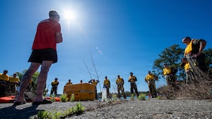 SERE specialist explains water survival skills on pier