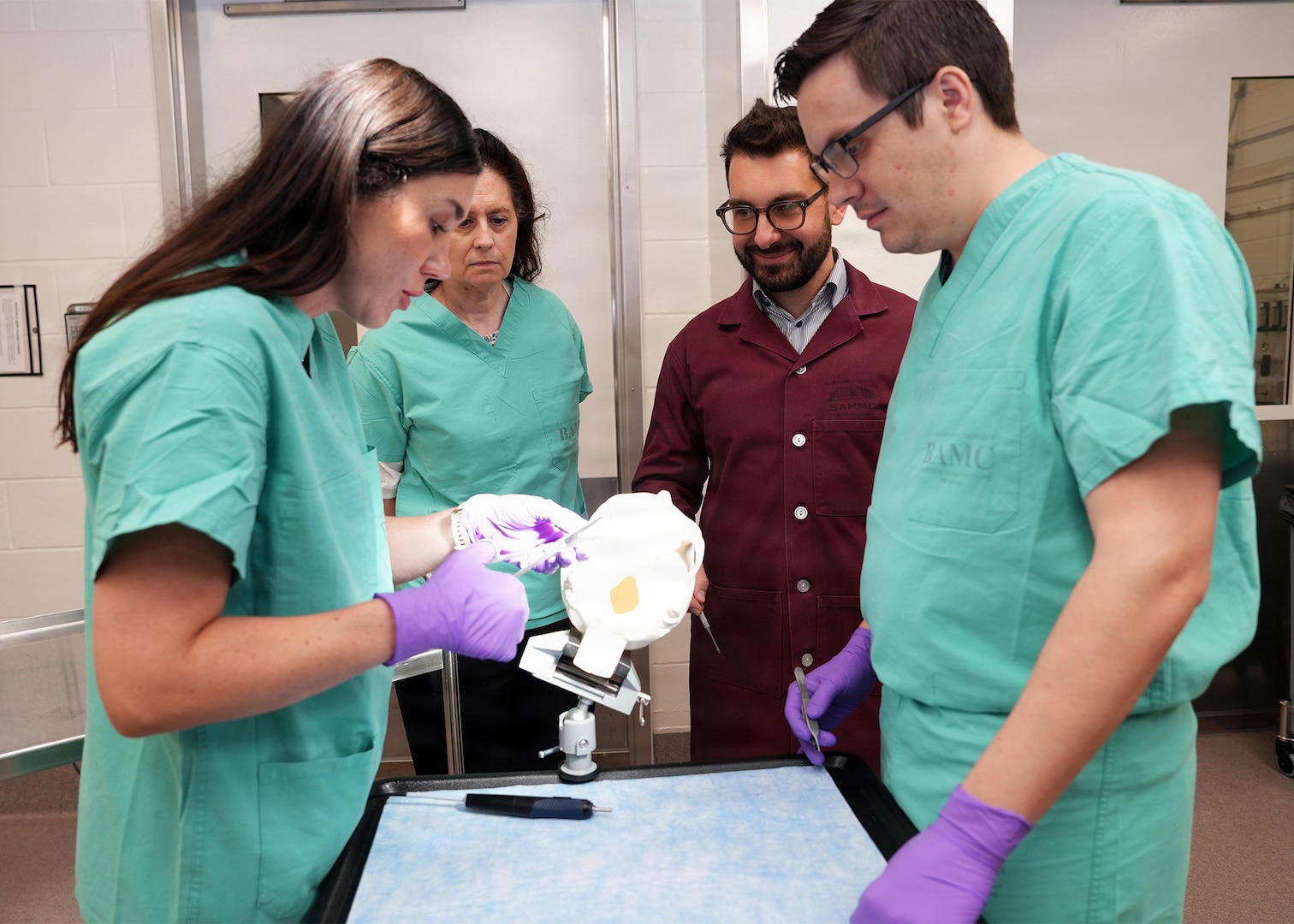 Joint Base San Antonio-Fort Sam Houston (May 15, 2026) Janaina Bortolatto, vice president of Clinical Operations for Cohesys, prepares BoneTape for application on an artificial skull during a demonstration of a new ultrasonic applicator for BoneTape resorbable fracture stabilization implant at the Battlefield Health and Trauma Research Institute. BoneTape, a flexible tape intended to stabilize broken bones around the face and head, has been a part of Naval Medical Research Unit (NAMRU) San Antonio’s research portfolio since 2024. Part of Navy Medicine Research & Development, NAMRU San Antonio supports Navy Medicine’s efforts to deliver expeditionary medicine systems, increase Sailor and Marine deployability, provide quality healthcare and recruit and retain medical personnel through gap-driven combat casualty care, craniofacial and directed energy research. Navy Medicine’s 44,000+ talented and ready forces optimize health readiness, deliver quality healthcare, and provide global expeditionary medical support to warfighters. (U.S. Navy Photo by Burrell Parmer /Released)