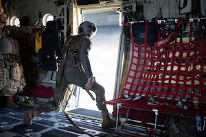 Royal New Zealand Air Force Sgt. Adam Wilson, a No. 40 Squadron air load master, looks out the open troop door of a C-130J Super Hercules aircraft flying in the Joint Pacific Alaska Range Complex during a RED FLAG-Alaska 26-2, June 3, 2026. The formation flight brought together U.S., United Kingdom, Canadian and New Zealand forces to improve integration and strengthen multinational partnerships.