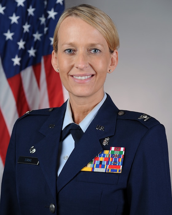Col. stall in front American flag