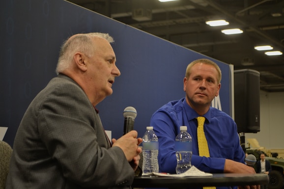 Bill Kenny, DLA Troop Support Executive Director of Contracting and Acquisition Management, and John Fafara, Director of Procurement, address attendees at the "knowledge bar" during the DLA Supply Chain Alliance Symposium & Exhibition in Columbus, Ohio, June 3, 2026. The leaders provided a command overview and answered questions on how to navigate the federal procurement process.