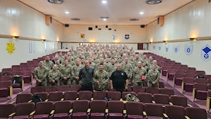 People pose for a picture in a theater